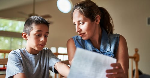 Mother reviews a paper with a young child