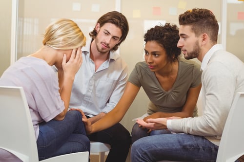 person grieving with support